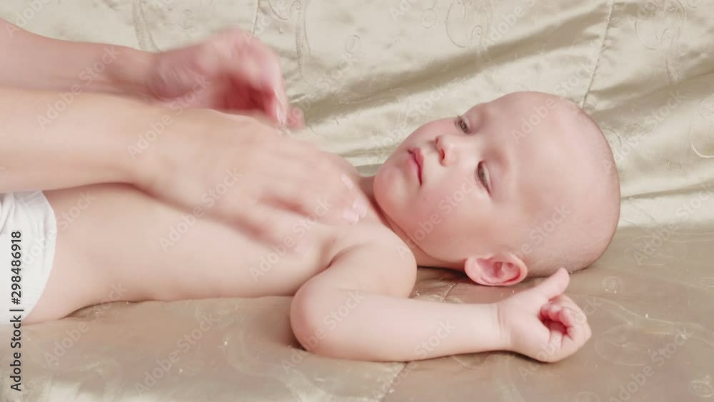 Shot of massage professional therapist does for two years old baby boy child rehabilitation massage Shot of massage professional therapist does for two years old baby boy child rehabilitation massage