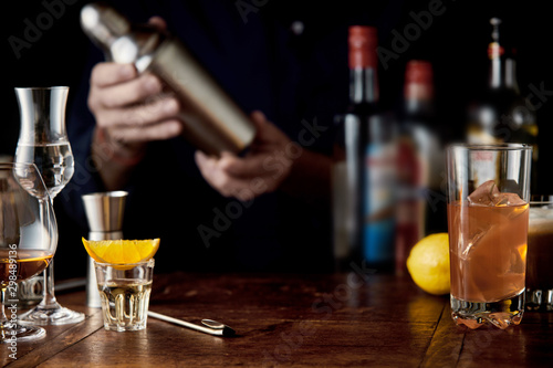 Barman mixing cocktails in a martini shaker