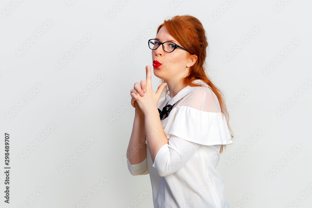 Happy smiling young woman making with hands fingers sign like shooting at white background copy space Happy smiling young woman making with hands fingers sign like shooting at white background copy space
