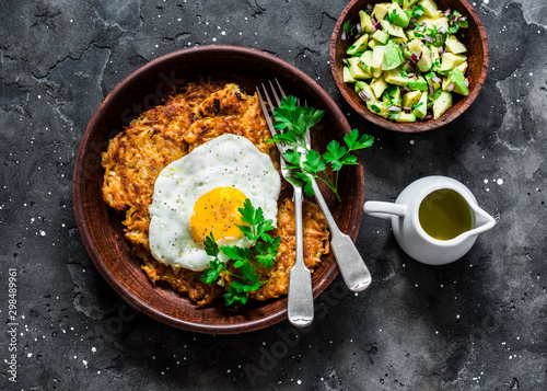 Obraz na plátně Pumpkin rostis with fried egg and avocado salsa on dark background, top view