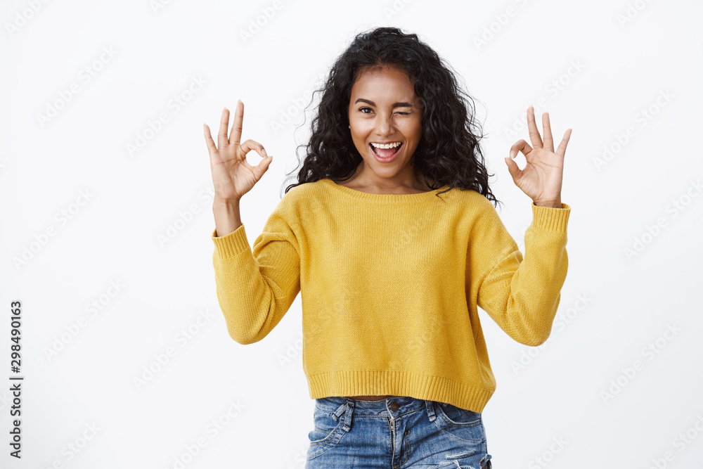 Girl rate amazing movie show okay signs. Cheerful sassy and successful african-american woman with curly hairstyle, wink, smiling satisfied, judging leave positive feedback, give approval