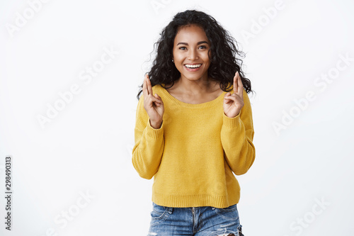 Lucky cheerful and confident african american pretty girl, wear yellow sweater, smiling happy cross fingers good luck, making wish believe dream will come true, standing encouraged white background