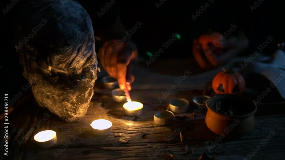 Witch praying their ceremony of curse by lighting candles in front of ...