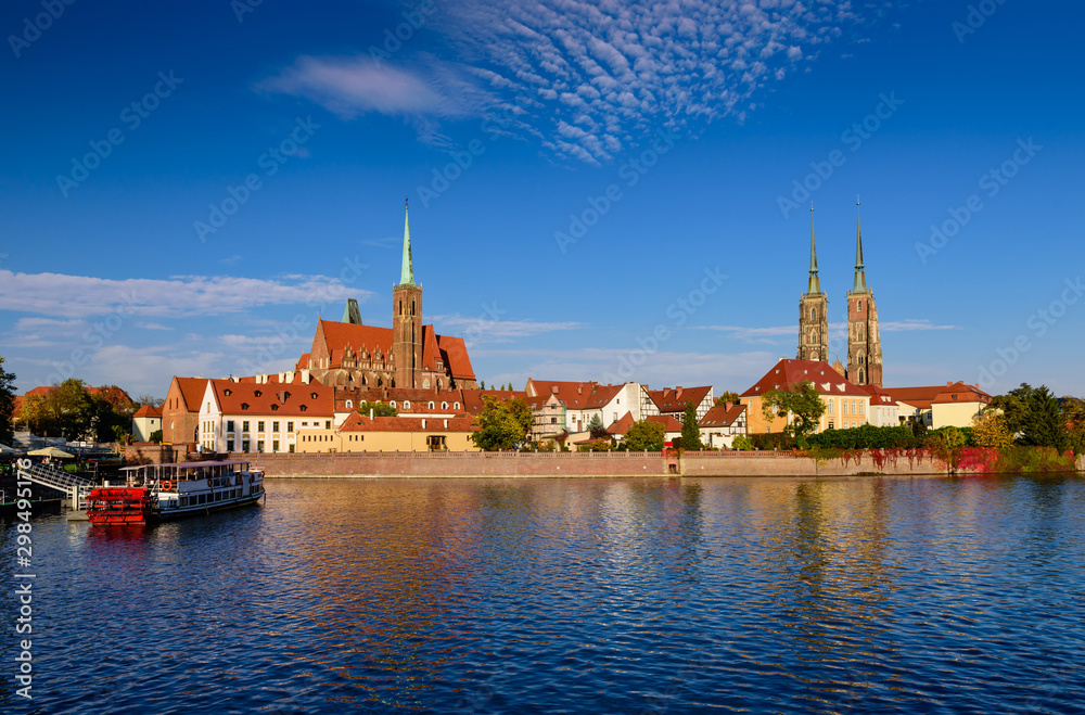 Obraz premium Sightseeing of Poland. Cityscape of Wroclaw. The view at Tumski island and Cathedral of St John the Baptist, Church of Our lady on the Sand, Odra river. 