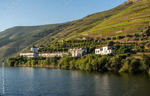 Whitewashed old Quinta or vineyard building on the banks of the River Douro in Portugal near Pinhao