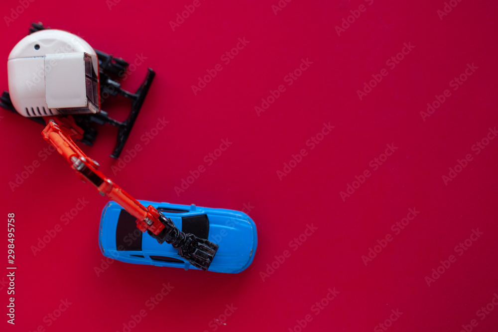 Naklejka premium Photo of a toy car on a red background.