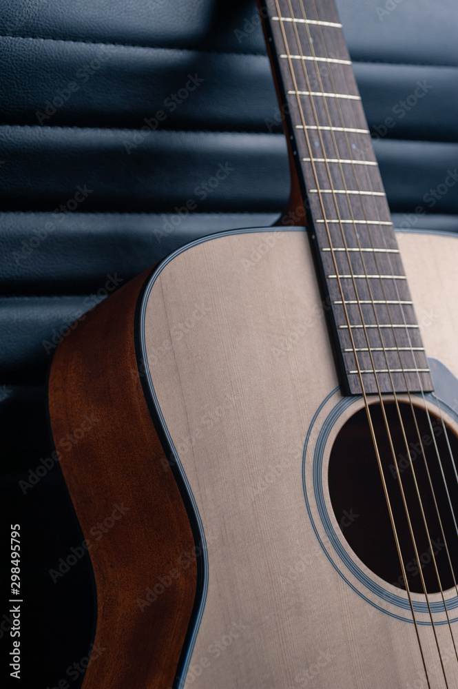 Fototapeta premium Beautiful guitar on a textured leather background.