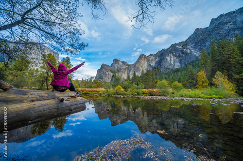 Back view of active woman backpacker enjoying valley and mountain view in yosemite national park, california. Active vacation Travel concept