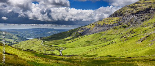 Panorama of the Struggle road at Kirkstone Pass leading to Windermere lake Ambleside with Red Screes mountain on right in Lake District England photo