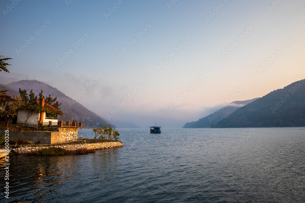 Obraz premium Boats on Danube river at sunrise near the Donji Milanovac in Serbia