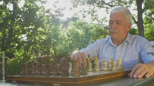 Old man opens the chess game with white pawn on E4