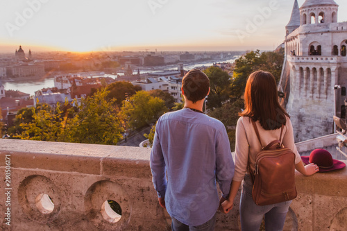 Young couple enjoy the view from the point from Fisherman Bastion in Budapest during sunrise.