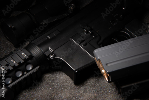 Quadro em tela dark assault rifle on dark grey foam with brass bullet in magazine ammo ready to