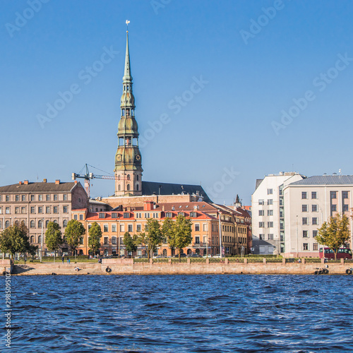 View of the original spire of St. Peter's Church from the Daugava River. City landscape, Riga, Latvia.