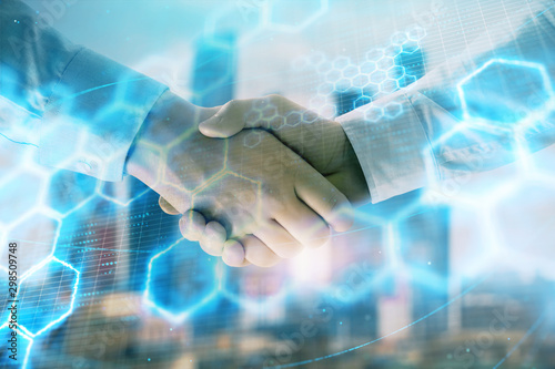 Double exposure of abstract technology drawing on cityscape background with two businessmen handshake. Concept of tech role in business