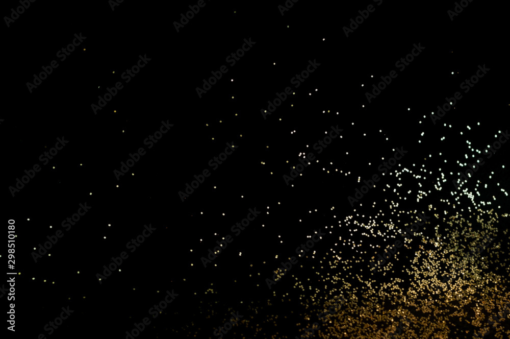 Black background with golden sparkles. Blurred effect. Concept for festive background or for project.Copy space Black background with golden sparkles. Blurred effect. Concept for festive background or for project.Copy space