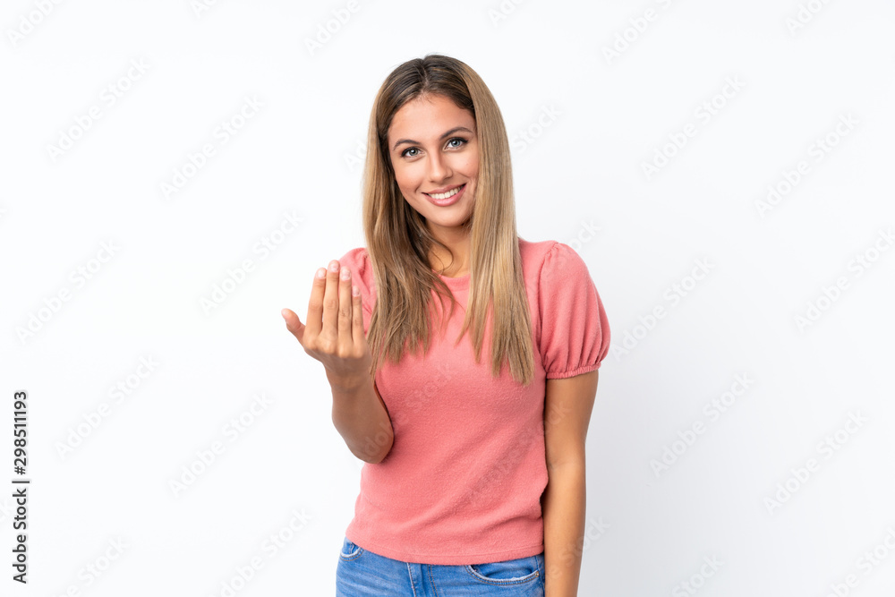 Young blonde woman over isolated white background inviting to come with hand. Happy that you came Young blonde woman over isolated white background inviting to come with hand. Happy that you came
