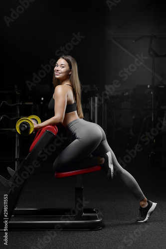 pretty caucasian fitness woman pumping up muscles workout fitness and bodybuilding concept gym.