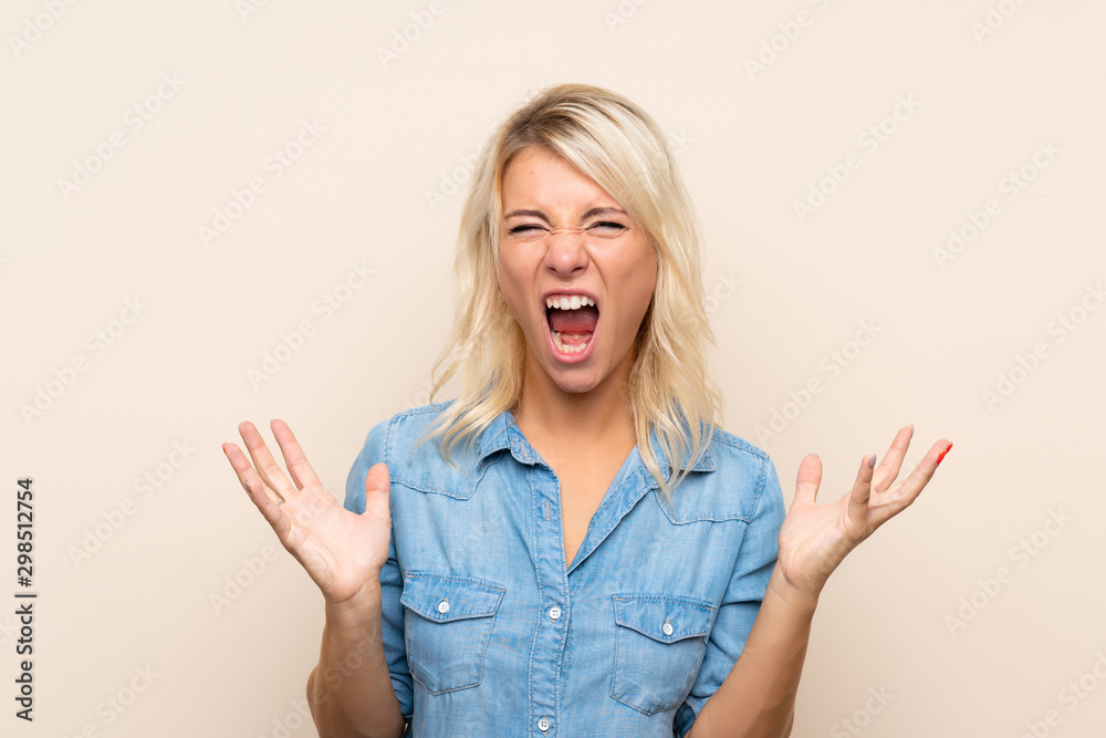 Young blonde woman over isolated background unhappy and frustrated with something Young blonde woman over isolated background unhappy and frustrated with something