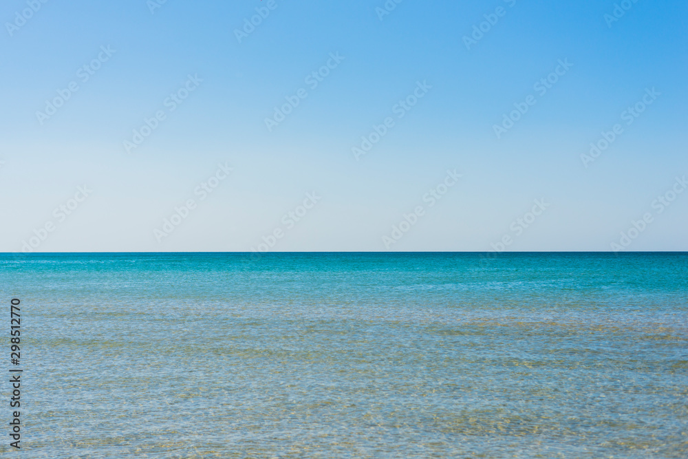 Background of sky and sea, sea is very calm with gentle ripples, sky perfectly clear