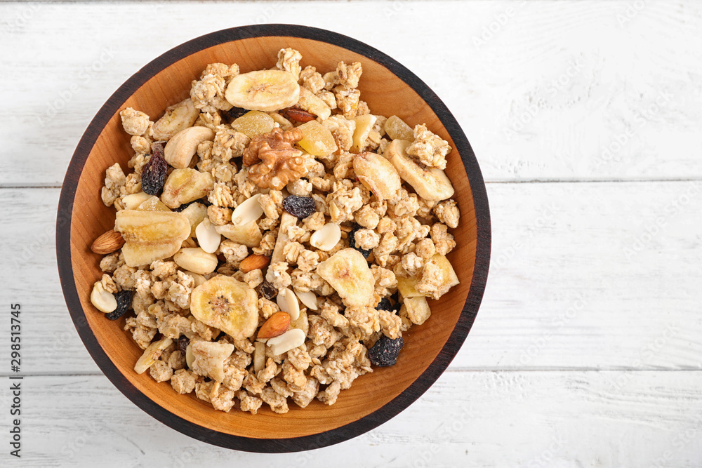 Tasty homemade granola on white wooden table, top view. Healthy breakfast Tasty homemade granola on white wooden table, top view. Healthy breakfast
