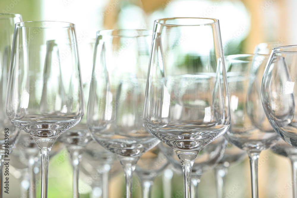 Empty glasses against blurred background, closeup view Empty glasses against blurred background, closeup view