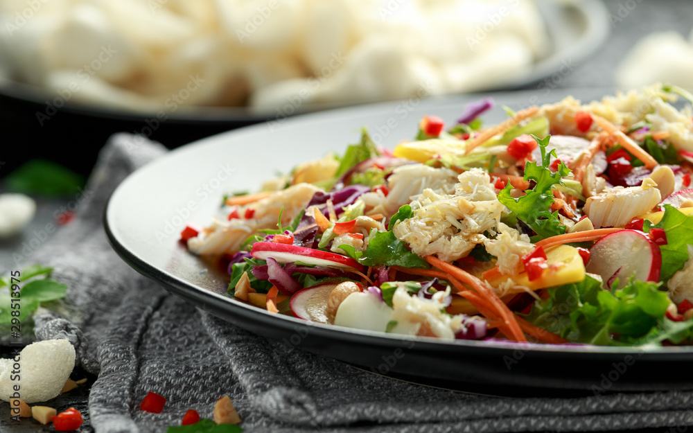 Crab salad with vegetables, radish, carrots, mango, pine nuts and prawn crackers Crab salad with vegetables, radish, carrots, mango, pine nuts and prawn crackers
