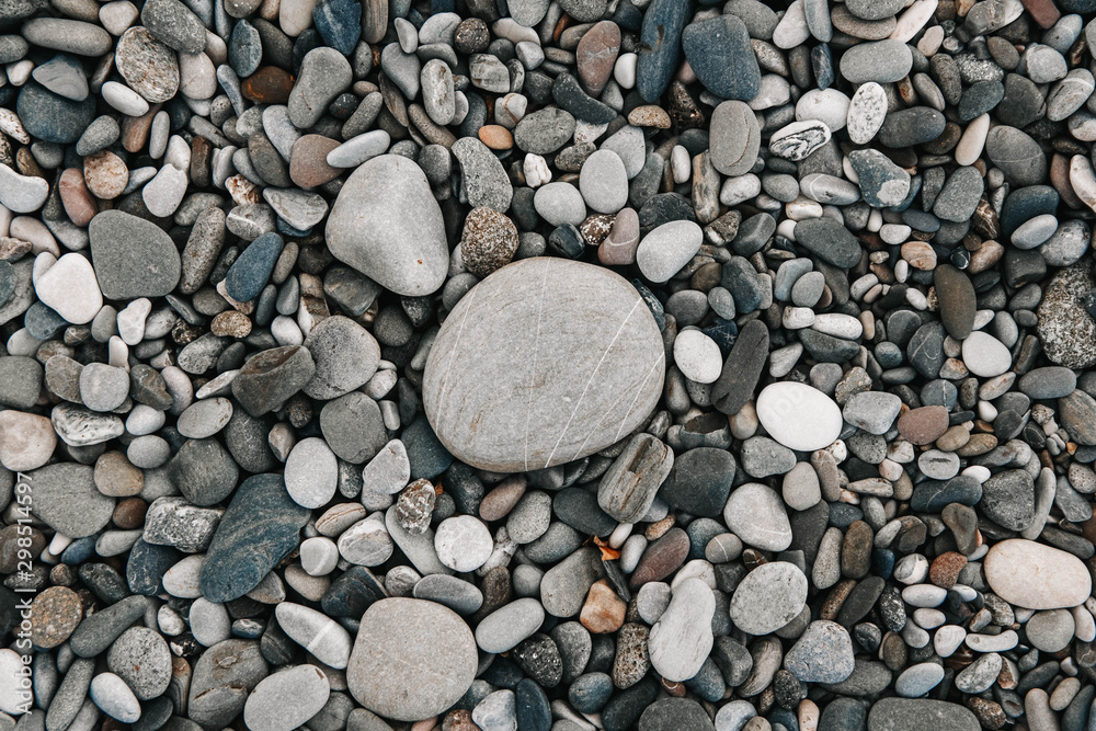 Gravel pattern of colored stones. Abstract nature pebbles background. Stone background. Sea peblles beach. Top view. Gravel pattern of colored stones. Abstract nature pebbles background. Stone background. Sea peblles beach. Top view.
