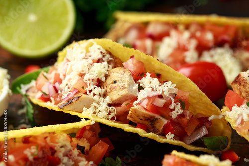 chicken tacos with salsa, cheese and corn tortila photo