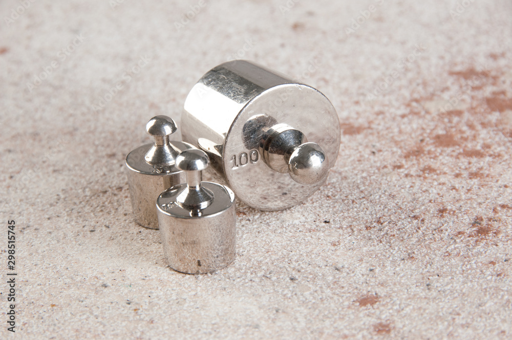Antique weights for scales on concrete background. Antique weights for scales on concrete background.