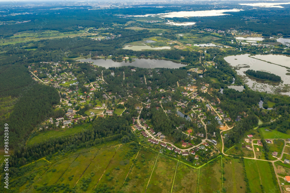Beautiful landscape. Latvian nature. Forest, town and lakes. View from above.