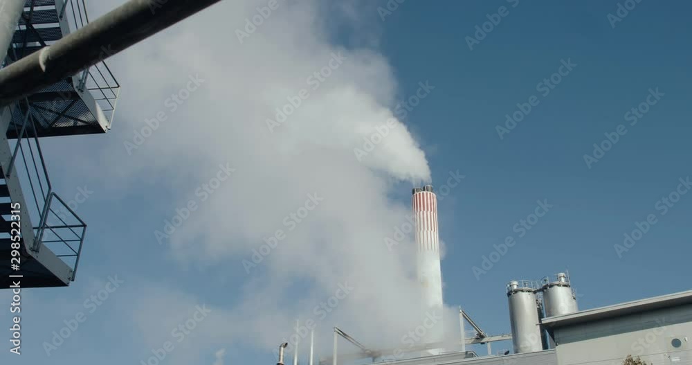 Billowing steam from a chimney of a power plant. Turning waste into electricity. Billowing steam from a chimney of a power plant. Turning waste into electricity.