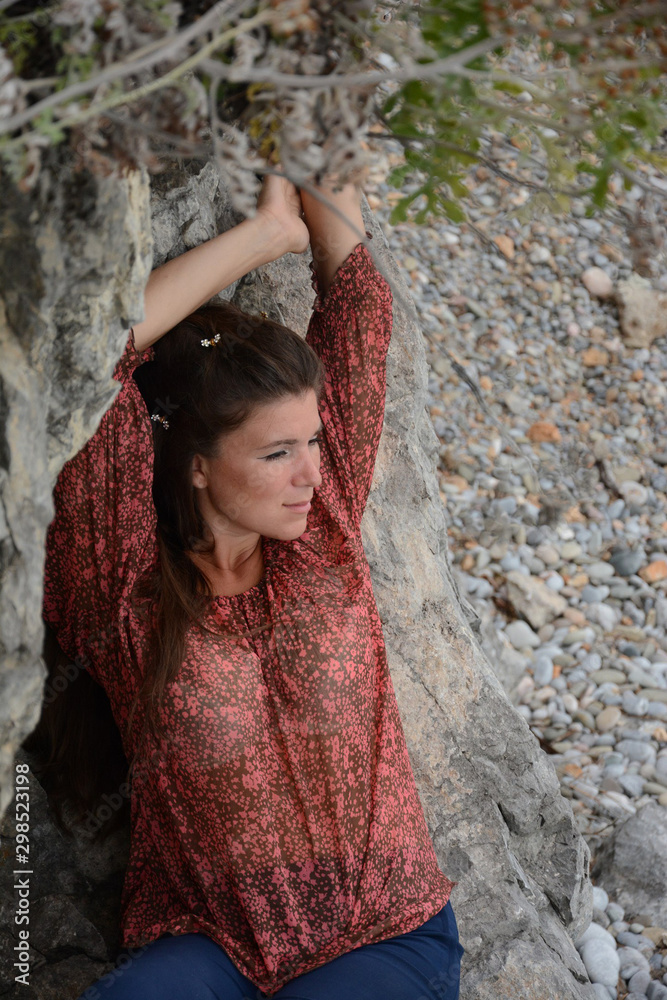 Happy woman relaxing and enjoying at the beach during travel holidays vacation outdoors at ocean or nature sea Happy woman relaxing and enjoying at the beach during travel holidays vacation outdoors at ocean or nature sea