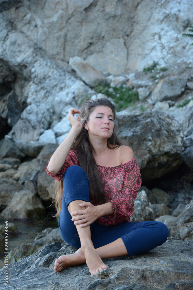 Happy woman relaxing and enjoying at the beach during travel holidays vacation outdoors at ocean or nature sea at sunset time Happy woman relaxing and enjoying at the beach during travel holidays vacation outdoors at ocean or nature sea at sunset time