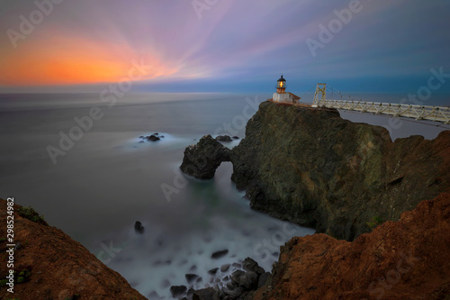 A view westward of Point Bonita Light House in the Marin Headlands of Northern California near San Francisco, after the sun has set with the blur of the ocean crashing on the waves below