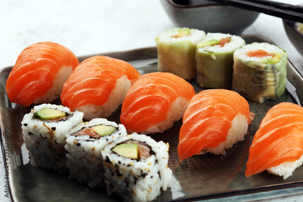 close up of sashimi sushi set with chopsticks and soy - sushi roll with salmon and sushi roll with smoked eel close up of sashimi sushi set with chopsticks and soy - sushi roll with salmon and sushi roll with smoked eel
