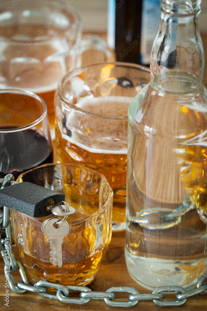 Problem with alcohol, Vodka,wine,whiskey,beer on the table locked with a chain and locked with a padlock, Concept