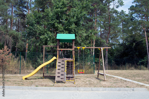 Tablou pe pânză Back Yard Wooden Swing Set on Green Lawn