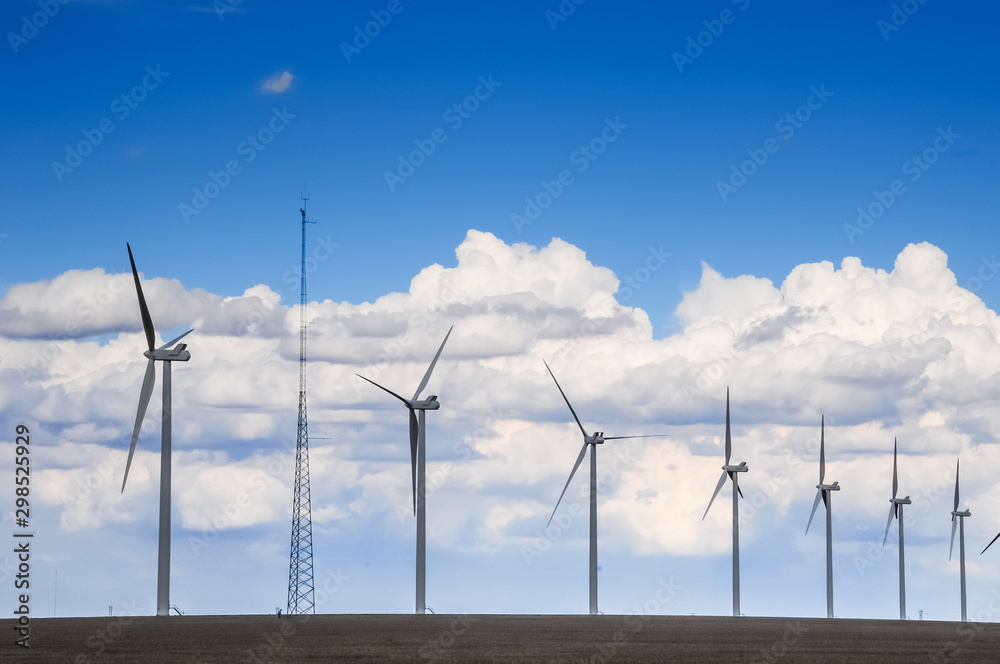 Wind turbine gererators with a cell tower on farmland Wind turbine gererators with a cell tower on farmland
