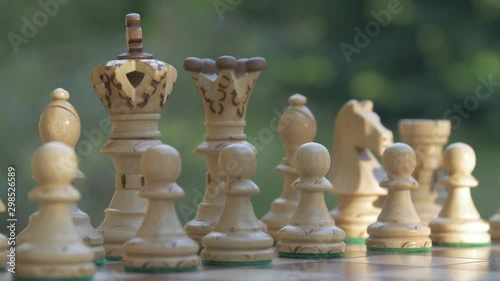 Wooden chess game on a table, focus sharpness relocation
