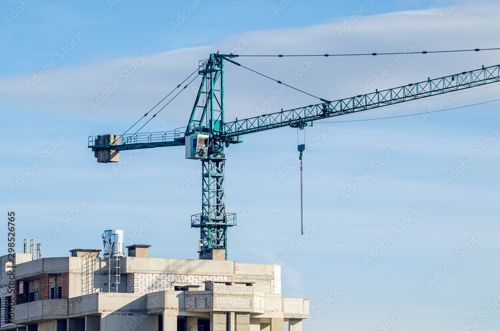 Construction site, tower crane on sky background