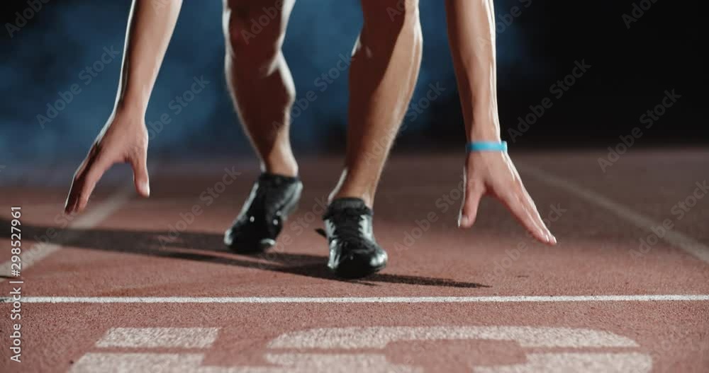 Asian athlete having an evening training, putting himself on starting position, then blasting off and sprinting, isolated on black background- sports concept 4k footage Asian athlete having an evening training, putting himself on starting position, then blasting off and sprinting, isolated on black background- sports concept 4k footage