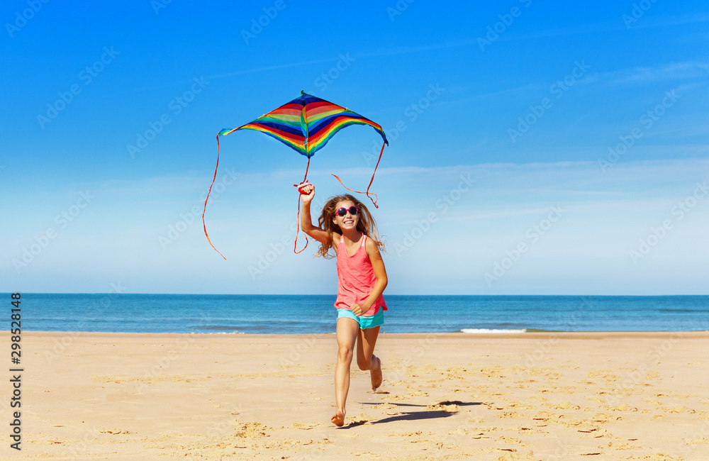 Happy little girls run with cute kite on the sand Happy little girls run with cute kite on the sand