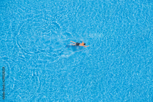 Man swimming in a pool, top view