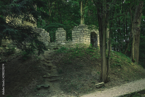 Halloween concept scenic photography of abandoned castle ruins from middle ages time in scary mystic forest  object of scary stories about ghosts 