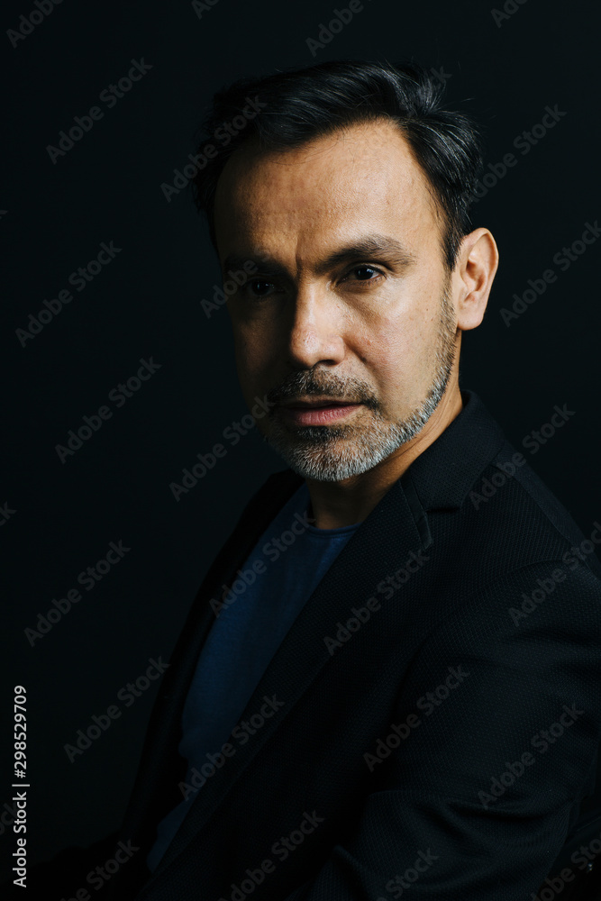 Portrait of a mature, stylish man on black studio background Portrait of a mature, stylish man on black studio background