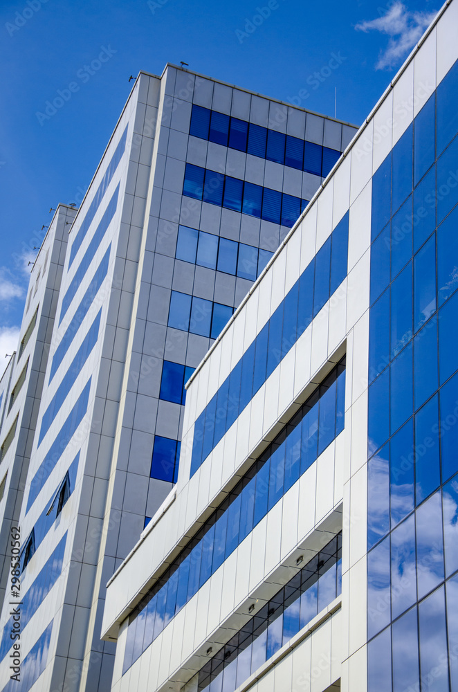 Architectural background, fragment of a modern office building against blue sky Architectural background, fragment of a modern office building against blue sky