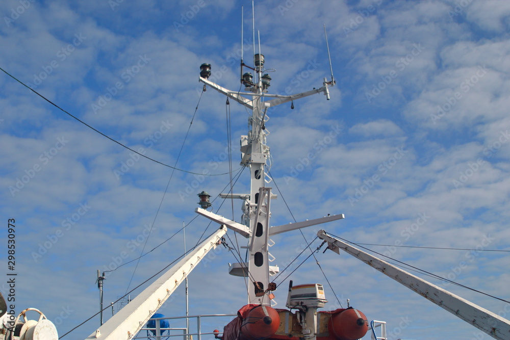 Rubber boat with motor and mast with navigation equipment on the deck of the vessel Rubber boat with motor and mast with navigation equipment on the deck of the vessel