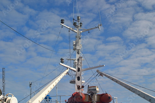 Rubber boat with motor and mast with navigation equipment on the deck of the vessel