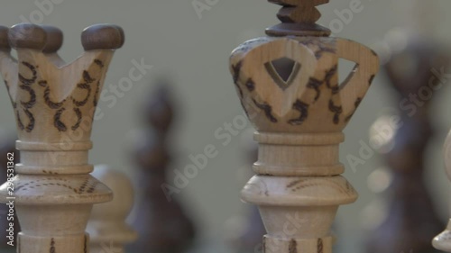 Wooden chess game on a table in a camera slide from left to right.